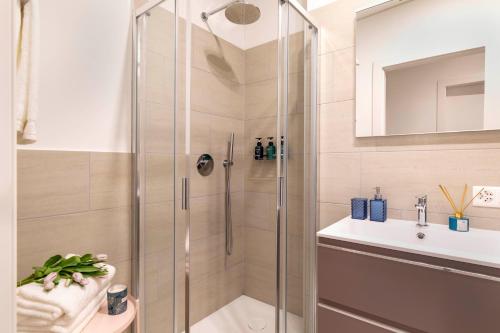 uma casa de banho com um chuveiro e um lavatório. em Central Superior Suites - Free Parking em Lugano