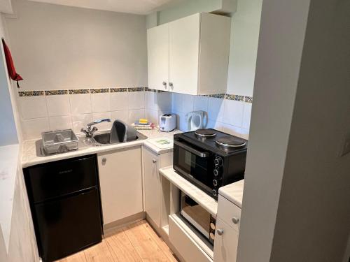 a small kitchen with a sink and a stove at Moorhead Country Holidays in Bideford