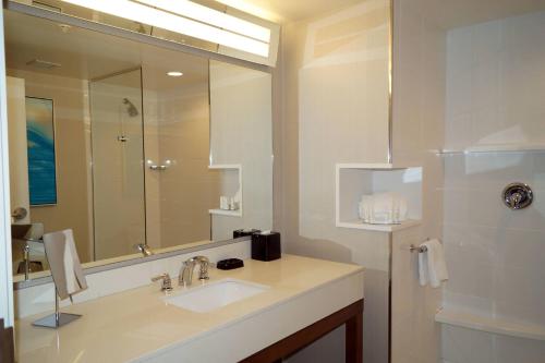a bathroom with a sink and a large mirror at Courtyard by Marriott Philadelphia Bensalem in Bensalem
