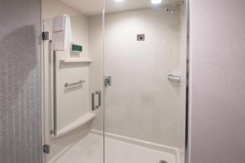 a shower with a glass door in a bathroom at Fairfield by Marriott Edmonton International Airport in Edmonton