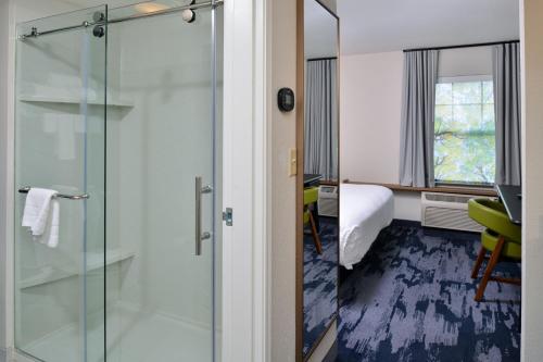 a bathroom with a glass shower in a hotel room at Fairfield Inn & Suites Goshen Middletown in Goshen