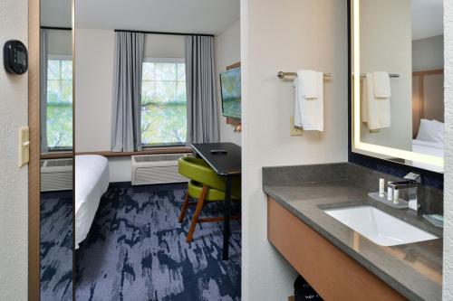 a hotel room with a sink and a mirror at Fairfield Inn & Suites Goshen Middletown in Goshen