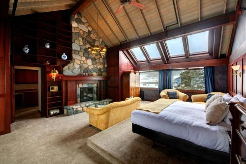 Casia Lodge and Ranch في Twisp: غرفة نوم بسرير كبير وموقد حجري