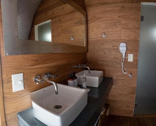 a bathroom with a sink and a mirror at Salinas Grandes Jujuy - Pristine Luxury Camp 