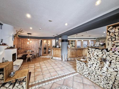 a large kitchen with a large stone wall at Hotel Lärchenhof in Kaunertal