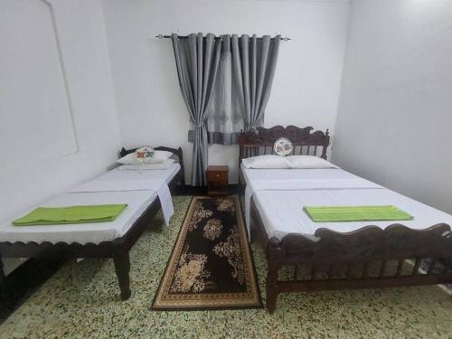 two beds sitting in a room with at Mombasa Comfort House, Old Town in Mombasa