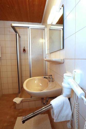 a bathroom with a sink and a shower at Gasthof Rebland in Eichstetten