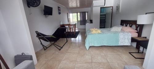 a bedroom with a bed and a table and chairs at Alojamientos N&S in Fortuna