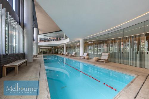 a large swimming pool in a large building at Melbourne Private Apartments - Collins Street Waterfront, Docklands in Melbourne