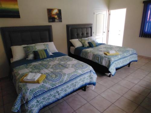 a bedroom with two beds and a window at Beach On The Rocks in El Zonte