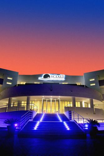 a building with blue lights in front of it at Hotel Scialì in Vieste