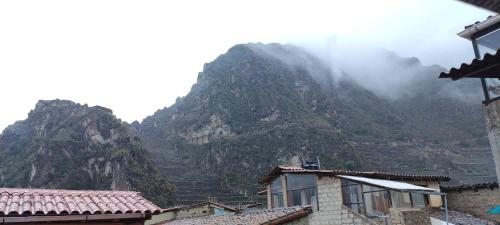 a view of a mountain with a village and buildings at Casa D´Maria in Ollantaytambo