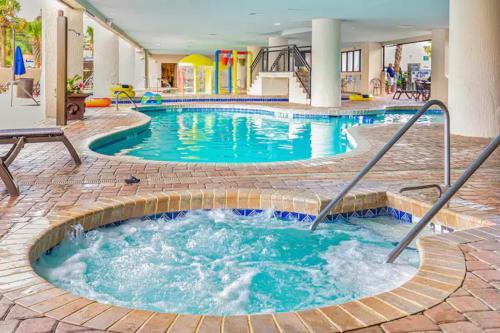 a pool in a hotel with a hot tub at Ocean Reef- Unique Oceanfront Condo-Free parking - Amazing pools in Myrtle Beach