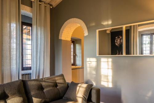 a living room with a couch and some windows at Relais La Martina in Pietraviva