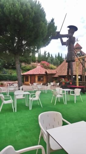 a statue of a man with a gun and tables and chairs at El Mirador de la Mancha in Villarrubia de los Ojos