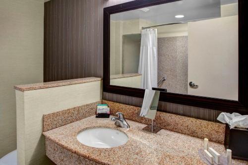 a bathroom with a sink and a large mirror at Courtyard Richmond North/Glen Allen in Richmond