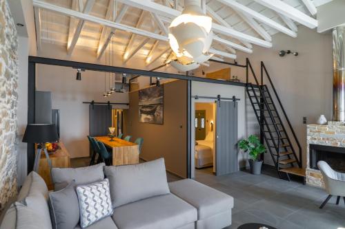 a living room with a white couch and a staircase at Seafront Karma Luxury - An Escape From Reality in Kato Gatzea