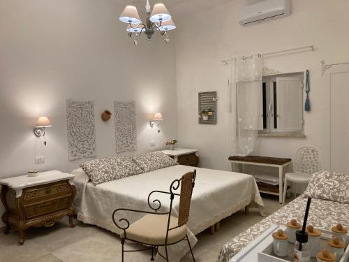 a bedroom with a bed and a table and a chair at Il Casale Di Kevin in Monopoli