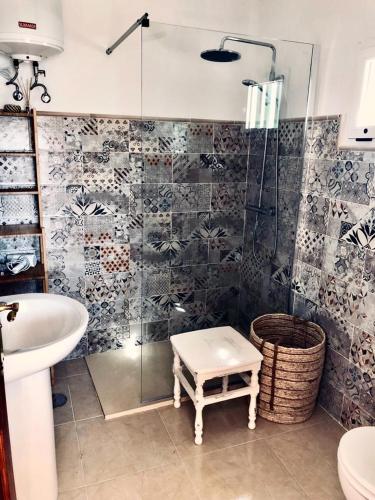 a bathroom with a shower and a sink and a toilet at Casita Volcan Lanzarote in Ye