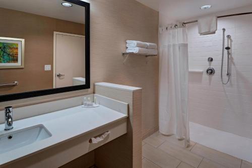 a bathroom with a sink and a shower with a mirror at Fairfield Inn & Suites by Marriott Atlanta Peachtree City in Peachtree City