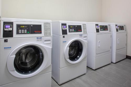 three washing machines are lined up in a laundry room at Fairfield Inn & Suites by Marriott Dallas Downtown in Dallas