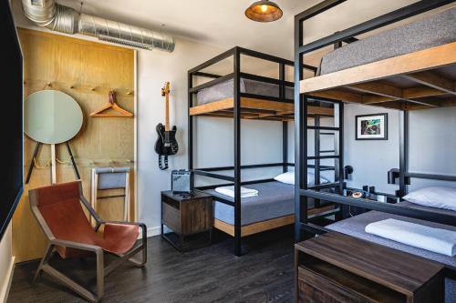 a room with bunk beds and a desk and a chair at MOXY Minneapolis Uptown in Minneapolis