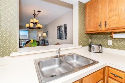 a kitchen counter with a sink and a mirror at Unit 3306 - Ocean & Racquet Resort in Saint Augustine Beach