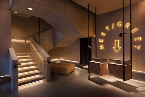 a staircase in a building with lights on the wall at Moxy NYC Chelsea in New York