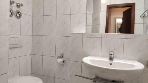 bagno con lavandino, servizi igienici e specchio di FeWo Kuhschelle, Oberstaufen-Steibis a Oberstaufen