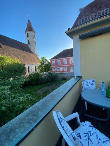 a view of a balcony with a table and a church at ALTSTADT-APARTMENTS Bad Radkersburg - Ihr Zuhause auf Reisen in Bad Radkersburg