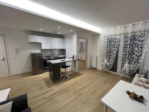 a living room with a kitchen and a dining room at Appartamento con due camere da letto e free park in Verona