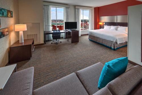 a hotel room with a bed and a couch at Residence Inn by Marriott Kansas City Downtown/Convention Center in Kansas City