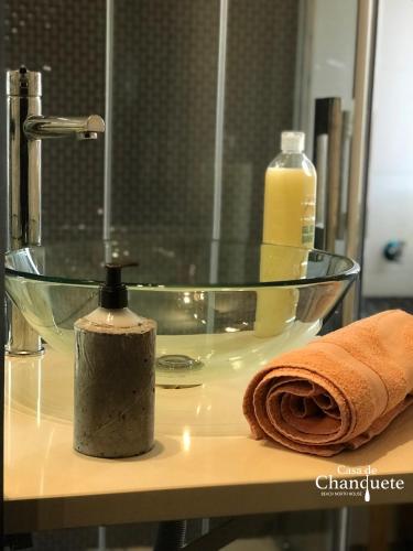 a glass sink with a towel and a bottle of soap at Casa de Chanquete in Viana do Castelo