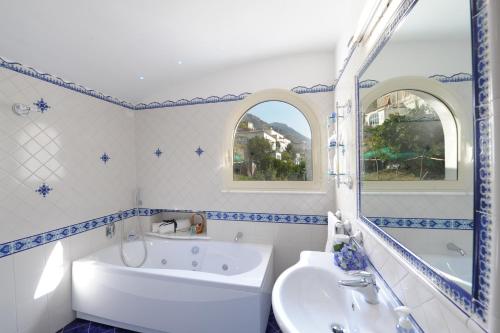 a bathroom with a tub and a sink at Alba di Praiano in Praiano