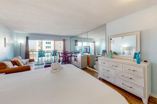 a bedroom with a large bed with a large mirror at Islander W 605 in Fort Walton Beach