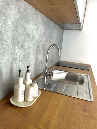 a kitchen counter with a sink and two soap bottles at Premium mobile home FJAKA - Oaza Mira Camping Croatia in Drage