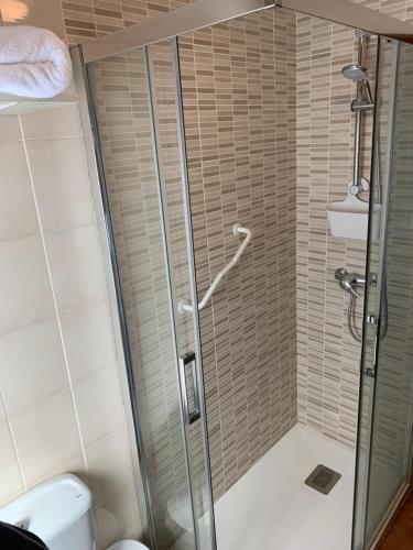 a shower with a glass door in a bathroom at La Buhardilla De Solavega - VV2530AS in Sevares