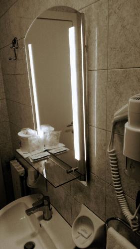 a bathroom with a sink and a mirror at Hotel Sanmicheli in Verona