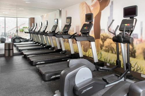 a row of cardio machines in a gym at TownePlace Suites by Marriott New York Long Island City in Queens