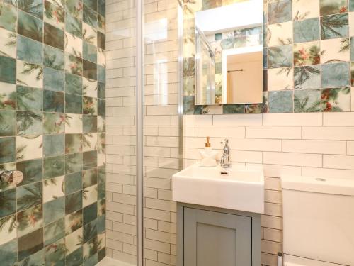 a bathroom with a sink and a shower at Seaside House in Weymouth