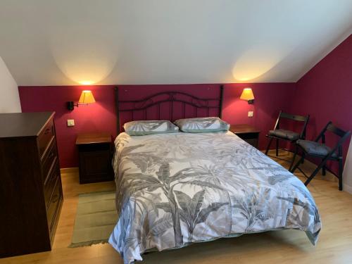 a bedroom with a large bed with purple walls at La Buhardilla De Solavega - VV2530AS in Sevares