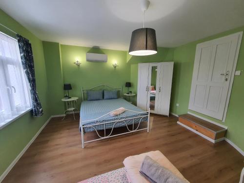1 dormitorio con paredes verdes y 1 cama. en HANCHO - OLD CITY PLOVDIV Center en Plovdiv
