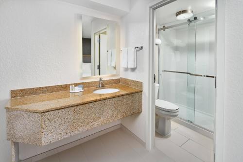 a bathroom with a sink and a toilet at SpringHill Suites Houston Hobby Airport in Houston