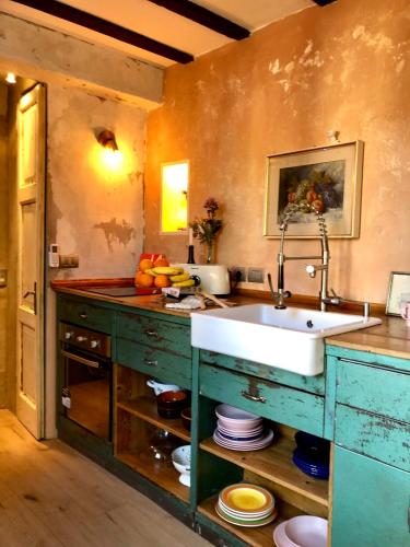 a kitchen with a sink and a counter at Charming and Design Attic Loft Central Milan in coolest area Navigli Ticinese in Milan