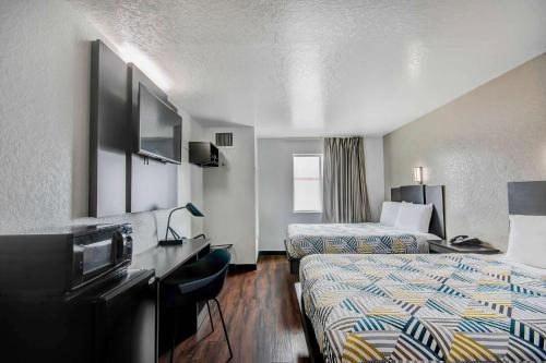 a hotel room with two beds and a television at Motel 6-San Antonio, TX - Sea World North in San Antonio