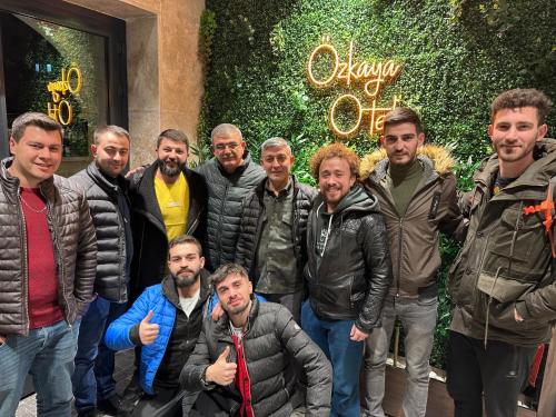 a group of men standing in front of a building at Özkaya hotel in Sivas