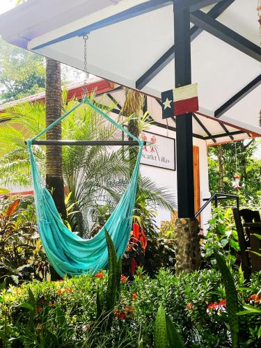 a hammock hanging from awning in a garden at The Scarlet Villas in Ojochal