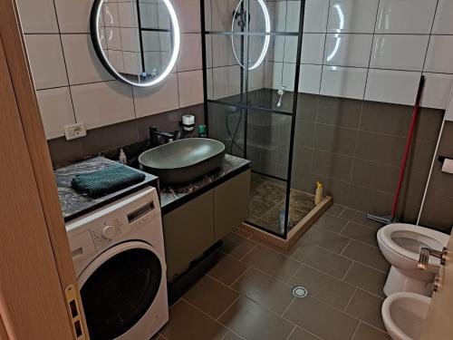 ein Badezimmer mit Waschbecken und Waschmaschine in der Unterkunft Vlora Bay in Vlorë