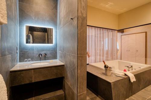 a bathroom with a tub and a sink at Ambleside Salutation Hotel & Spa, World Hotel Distinctive in Ambleside