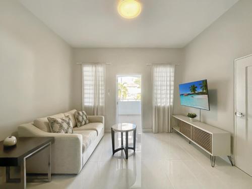 a living room with a couch and a table at Stunning 3-Bedroom Beachside Apartment in San Juan